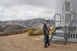 Field engineer viewing data after the inspection of turbines on a wind farm.