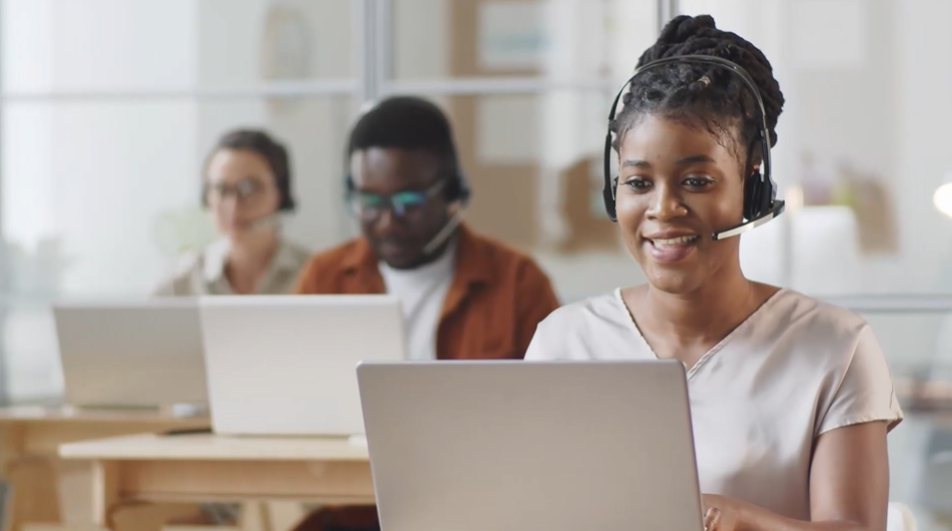 a person sitting at a table in front of a laptop