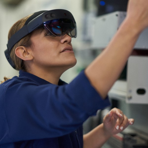 Field engineer inspects electrical substation server room on a wind farm using remote assist with HoloLens2