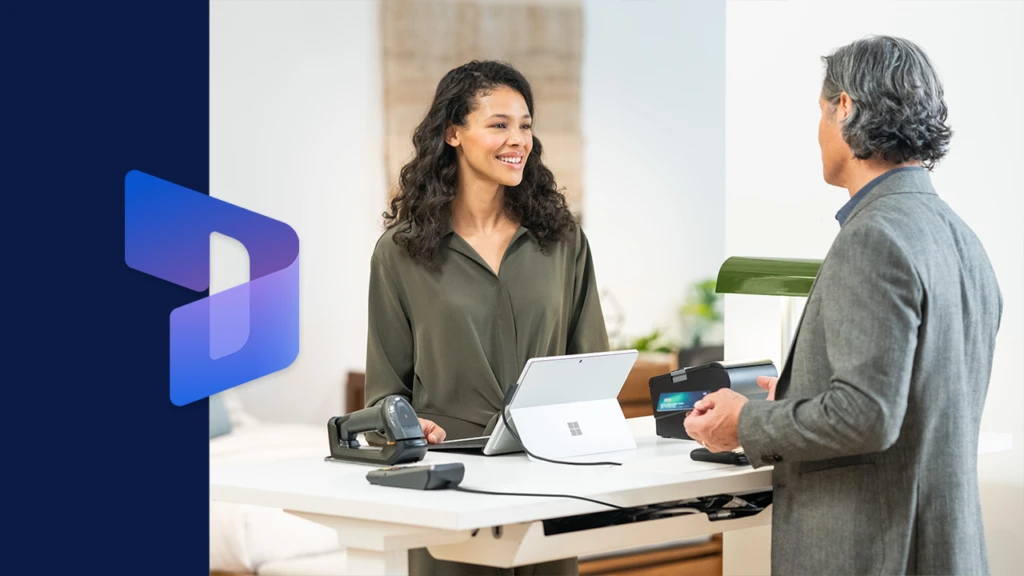 a man and a woman standing in front of a computer in a retail store