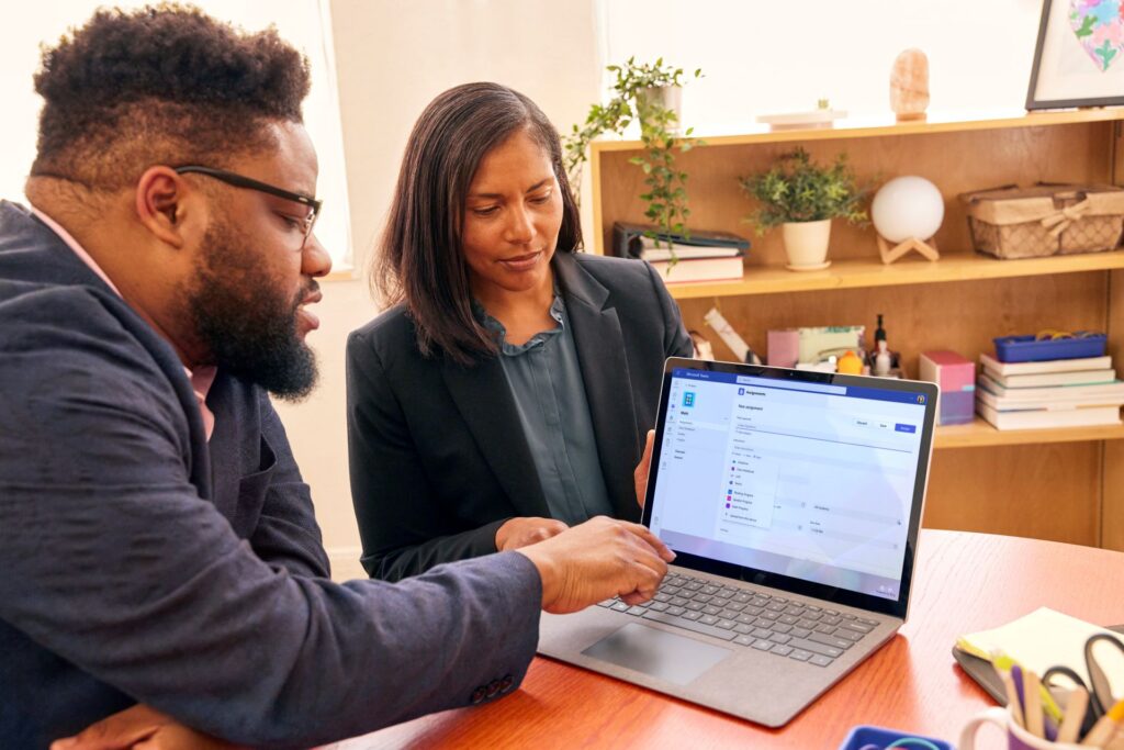 Two educators collaborate on a laptop, using Teams for Education.