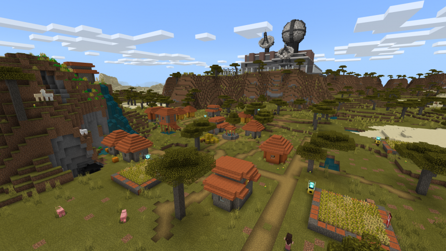 A satellite control compound sits on a mountain overlooking a village in a valley in Minecraft: Education Edition