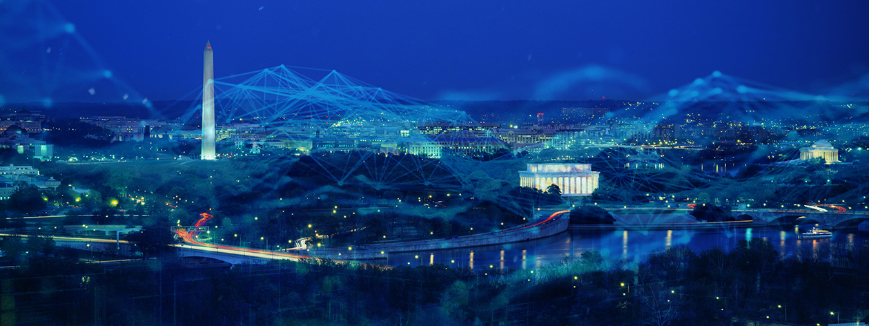 Nighttime aerial shot of DC monuments overlaid with glowing cyber web