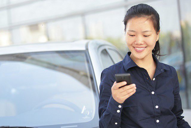 A woman looking down at her cellphone