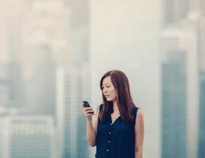 woman-in-city-looking-at-smartphone.1