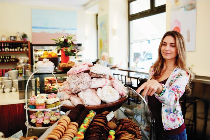 A woman at a bakery.