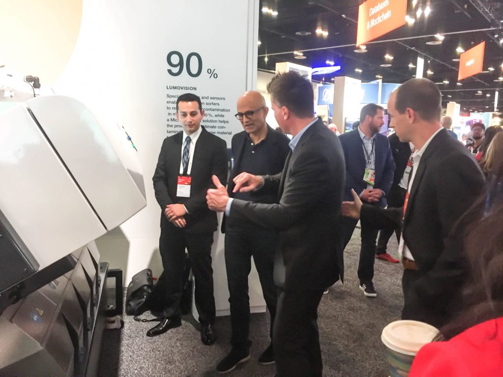 Microsoft CEO Satya Nadella gets a demo from Stuart Bashford, Chief Digital Officer from Bühler of LumoVision, showing the company's grain sorting technology that seeks out harmful toxins in grain to make food safer and reduce waste.