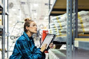 Employee with tablet in warehouse