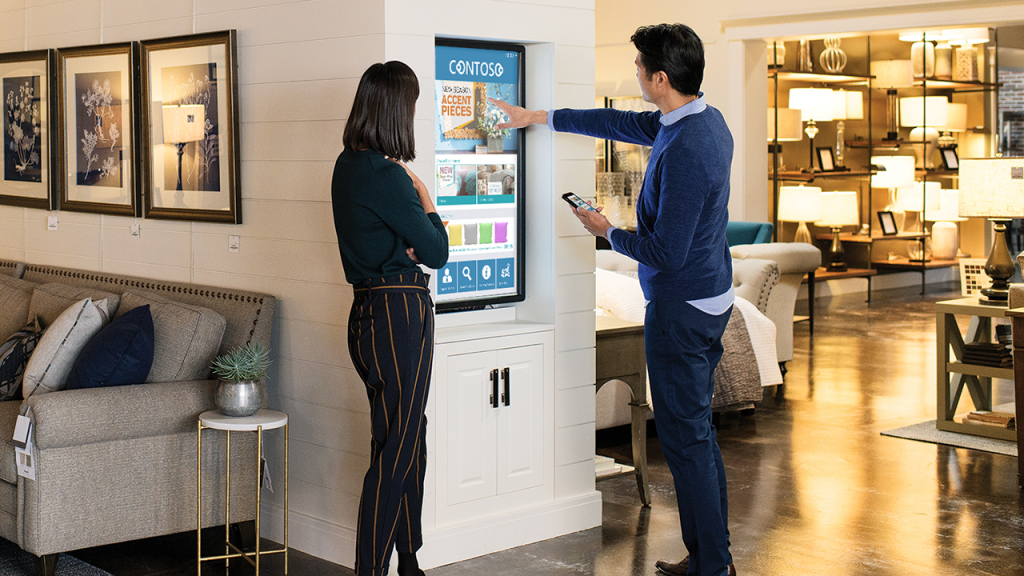 Contoso employee showing customer how to use technology