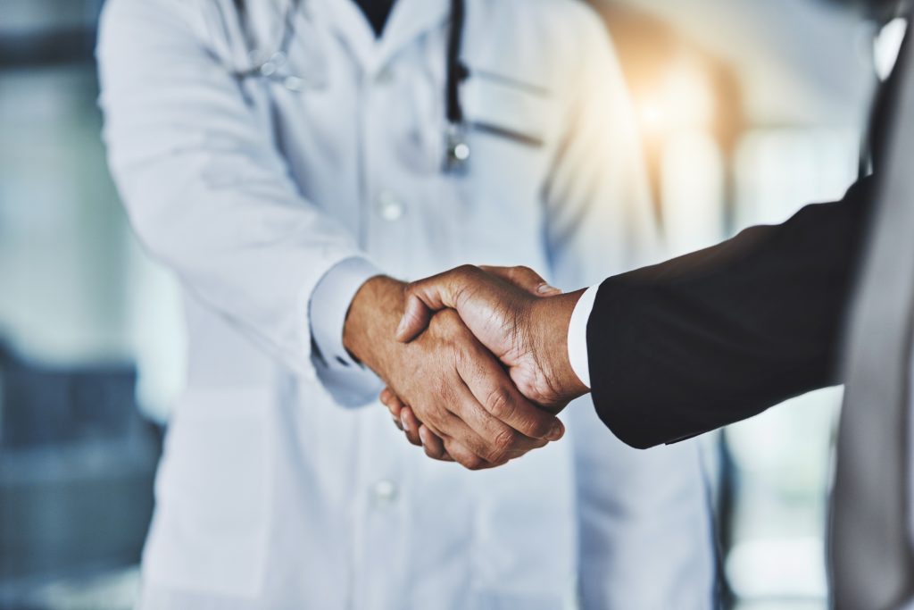 Doctor shaking hand with patient