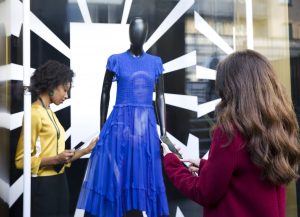 Retail worker creating clothing display