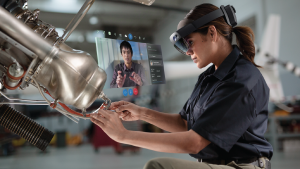 Woman using Hololens to work on machinery