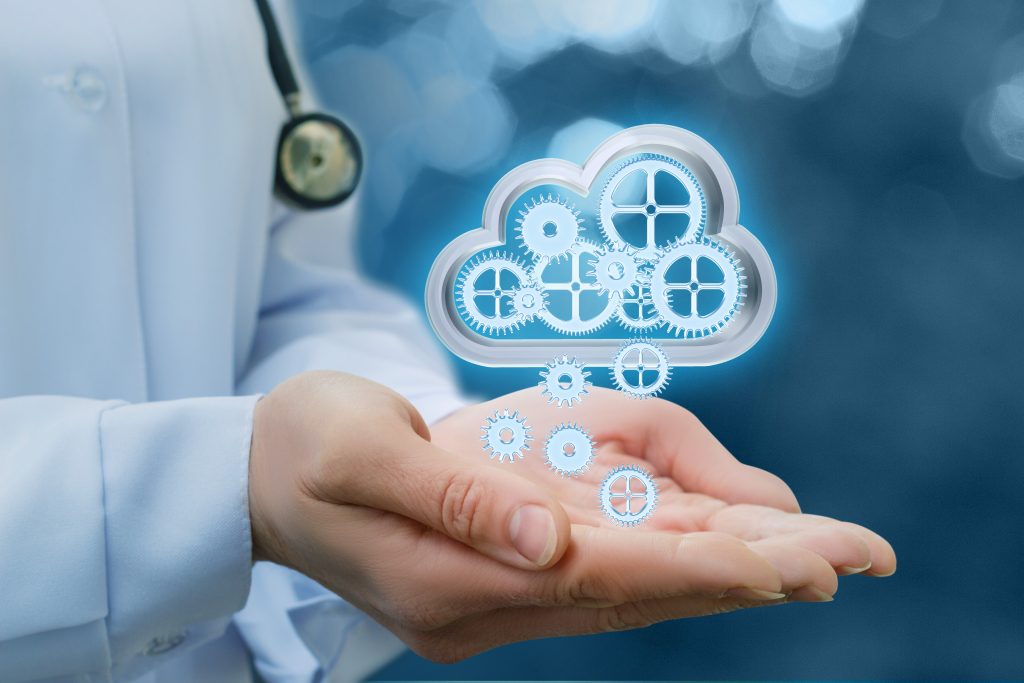 An image of a doctor with palms out holding a virtual computing cloud