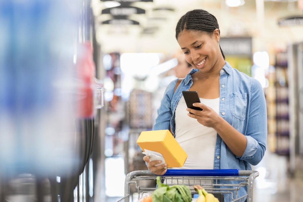 Woman uses grocery store mobile app while shopping
