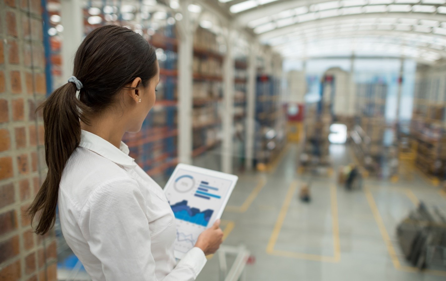 Person looking at device while working in a factory