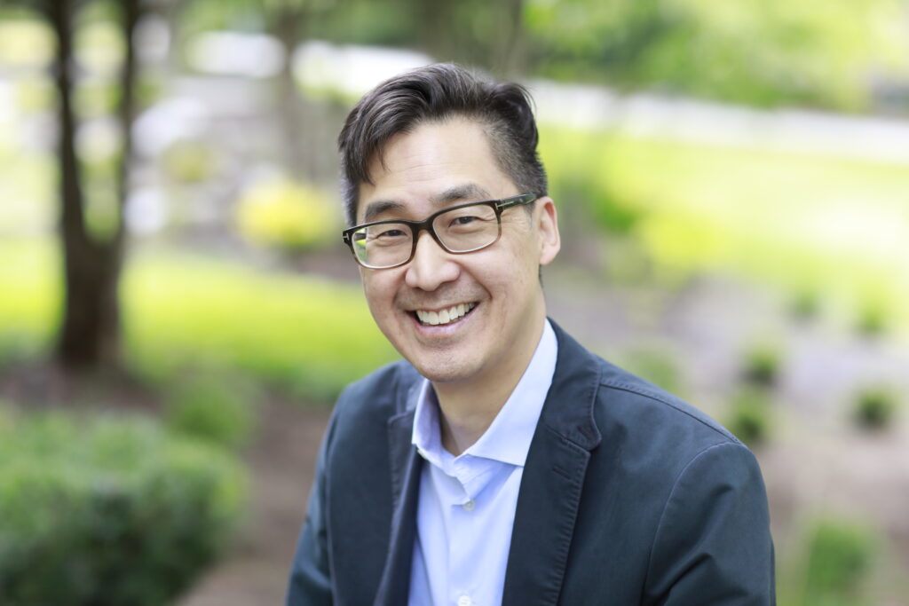 Headshot of Dr David Rhew sitting in a garden