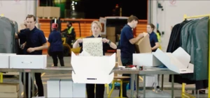 Three supply chain employees packaging appeal for shipment