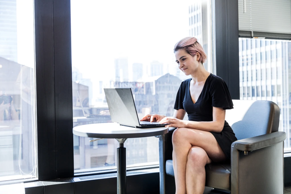 bank worker sitting at a table with a laptop