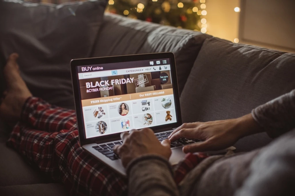 a man sitting on a couch using a laptop