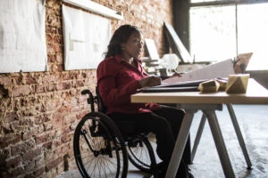 Businesswoman in wheelchair working at desk