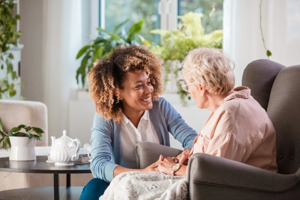 Home help helping the elderly woman with medication