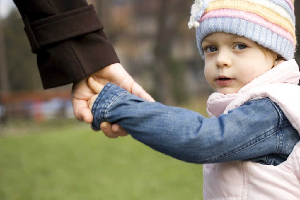 Child holding mother's hand