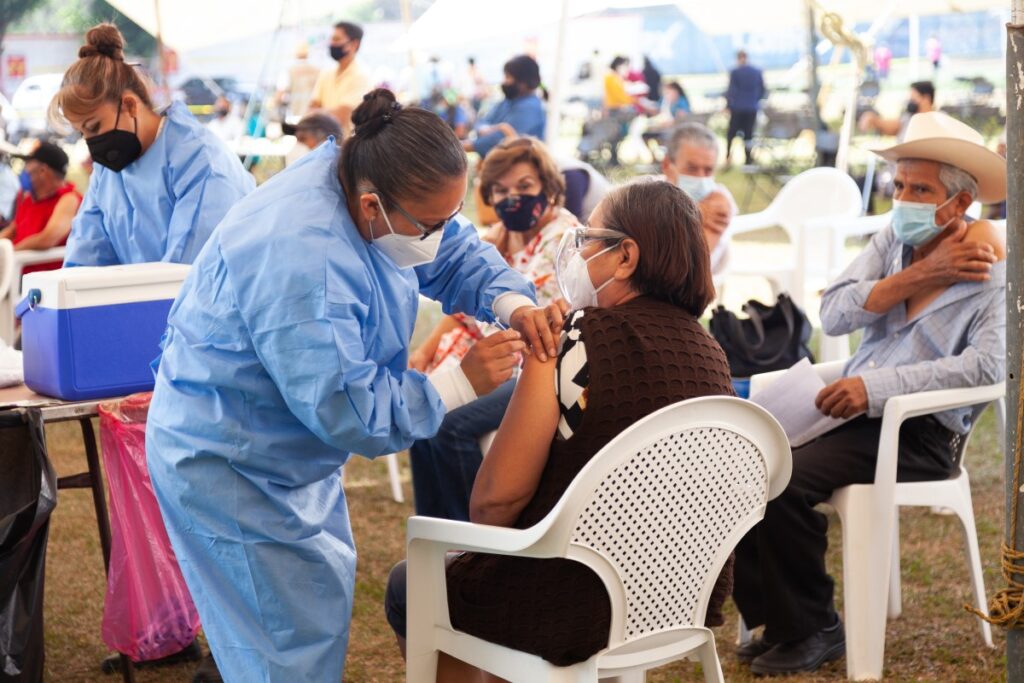 Group of people receiving vaccination.