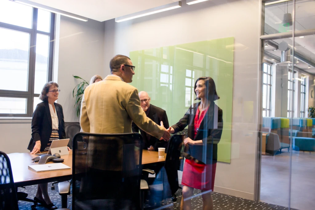 CEO greeting others in a meeting.