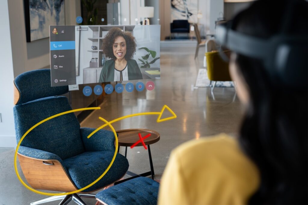 A retail manager using Dynamics 365 Remote Assist on HoloLens 2 to collaborate with a remote design expert to display in-store items with the help of 3D annotations