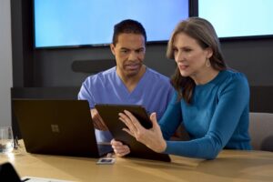 Male physician conducting meeting with female health insurance administrator