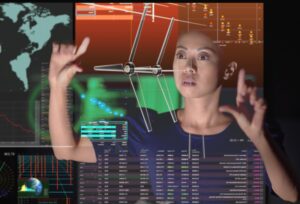 Asian woman working with a virtual touchscreen and expanding an image of a wind turbine in front of her.
