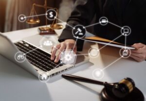 a judge using a laptop computer sitting on top of a table with surface and network icons.