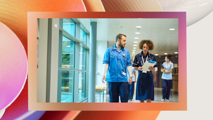 Four nurses walking along in a hospital.