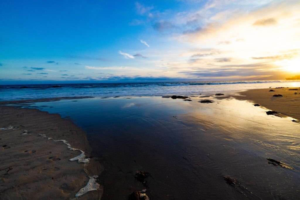 Sunset along an intertidal zone on the Pacific Ocean.