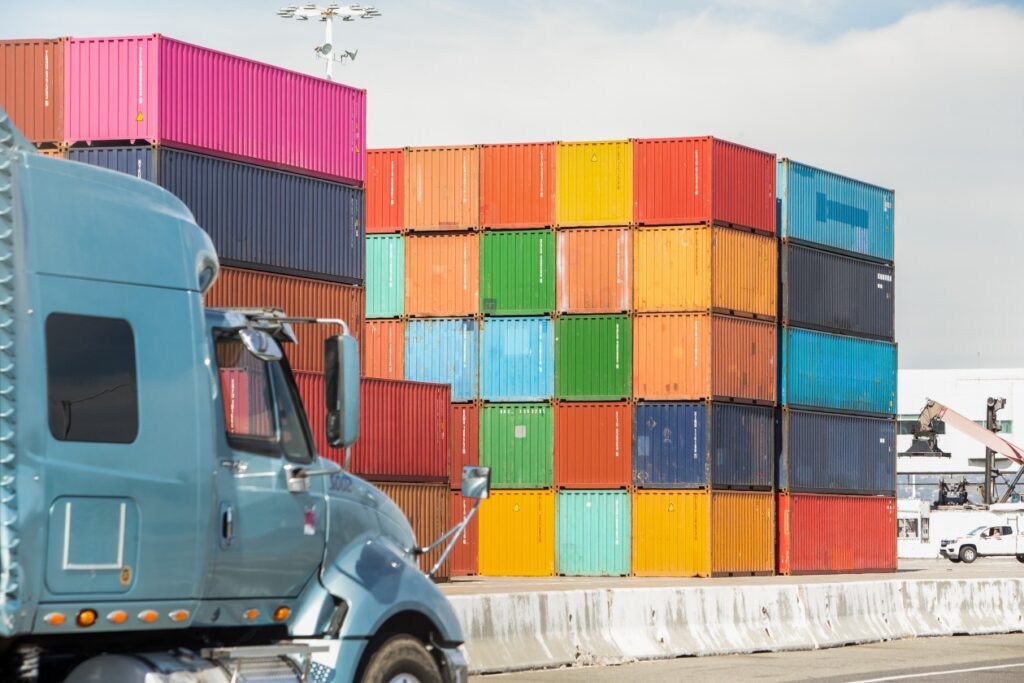 Tighter shot of colorful shipping containers; environmental shot.