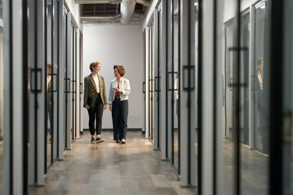 Two professionals collaborating in a modern, technology-enabled workplace.