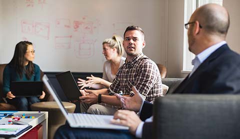 Four people talking to each other in pairs