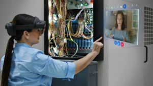 Woman interacing with Remote Assist hologram in a wiring project