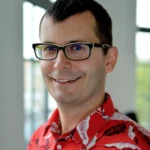 Picture of a smiling man in glasses and a Hawaiian shirt, Jedrzej Osinski