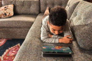 Child interacting with a laptop.
