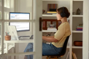 A woman working in her home office. Analytics can be used to improve business insight