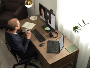 A man on a Teams video call. In an increasingly hybrid workplace, client expereinces will include remote video meetings.
