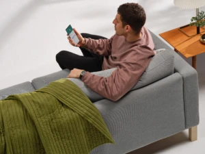 A man looking at his phone in his living room