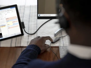 Adult male inside using Microsoft Modern USB Headset on video call