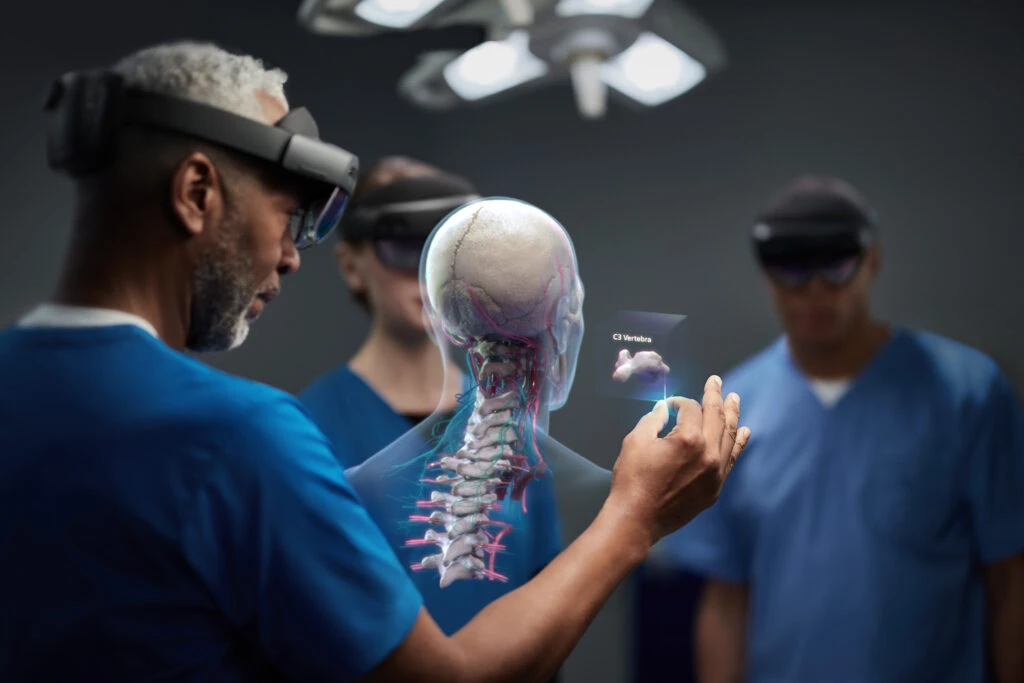 Group of doctors using Microsoft Hololens 2 to analyze a human vertebrae. Contains hologram scenario.
