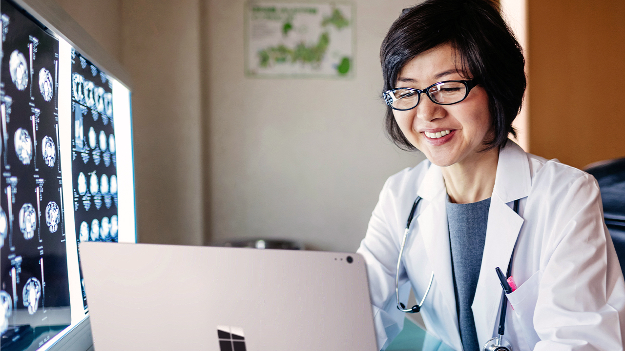 doctor smiling working on her laptop.