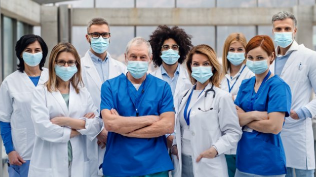 Group of nurses and doctors with facemasks.