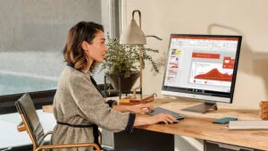 Woman looking at analytics on a desktop monitor