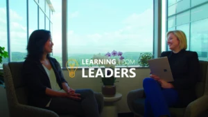 2 women sitting next to a window