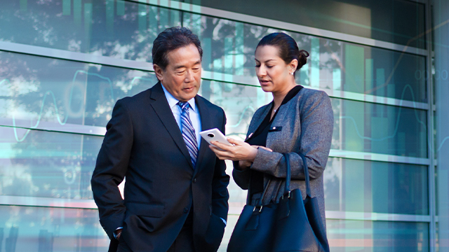 A man and a woman looking at a phone together